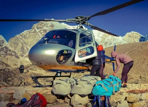 Guest heading to helicopter with their luggage